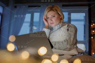 可悲的女人在公寓里使用电子设备