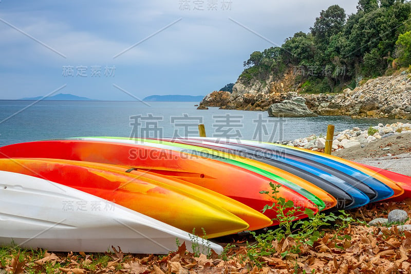 夏日海湾岸边的彩色皮划艇