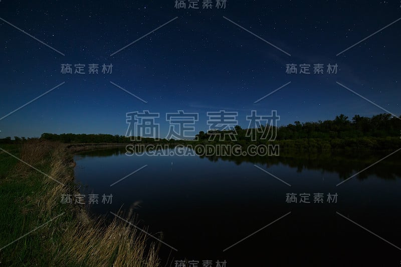 夜空中的星星倒映在河里。这风景是在月光下拍摄的。