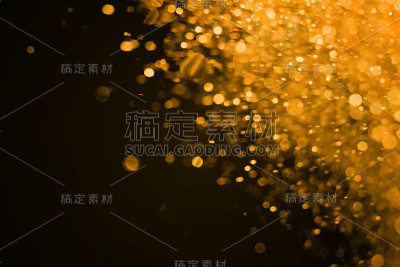 圣诞金箔闪耀闪耀爆炸尘埃颗粒背景与散景，金箔节日快乐新年和情人节