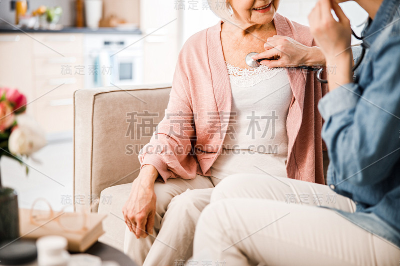 年轻女医生正在检查老太太的呼吸