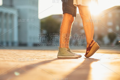 腿男和女孩拥抱在城市的背景