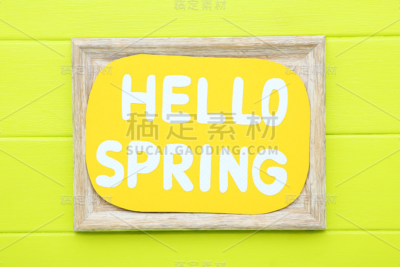 在绿色的木桌上发短信Hello Spring