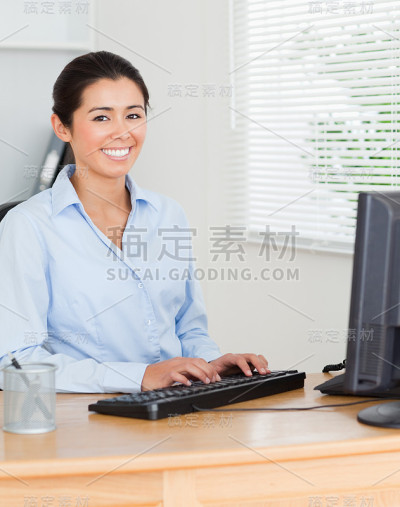 坐在电脑前工作的迷人女人