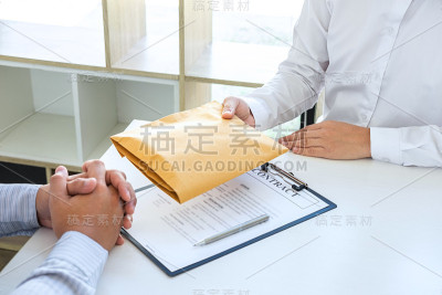 商人将贿赂的钱装在其合作伙伴的信封中，以给成功的交易合同一种腐败诈骗、非法、不诚实、贿赂和腐败的概念