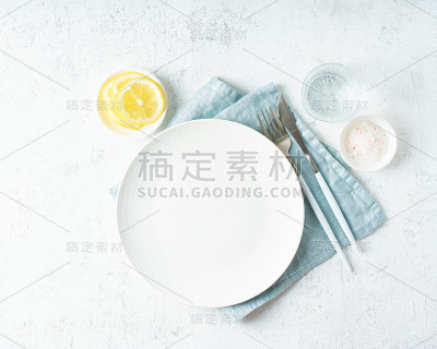 干净的白色盘子，水的杯子，刀叉放在白色的石头桌上，复制空间，模拟出来