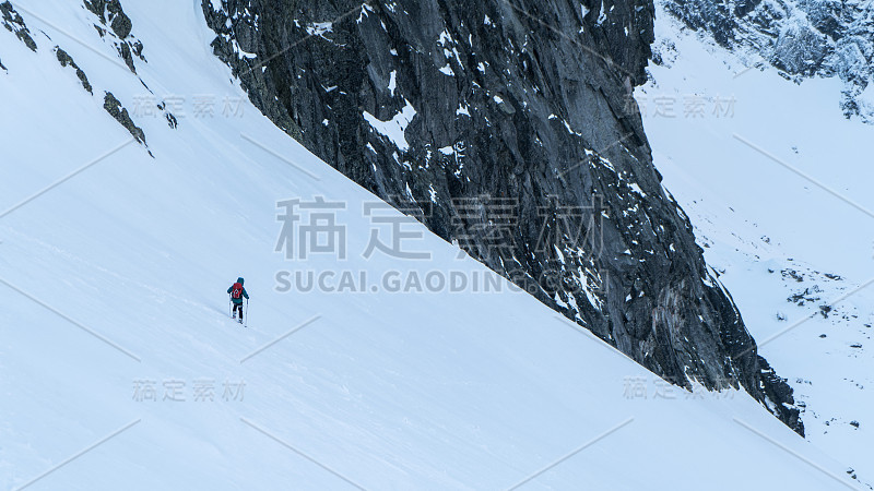 登山者在多雪的冬天在高山上徒步旅行