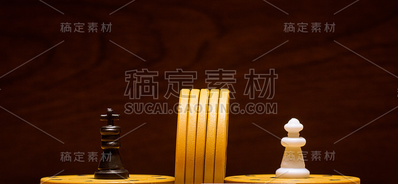 国际象棋国王和王后在一个深色的木制背景上