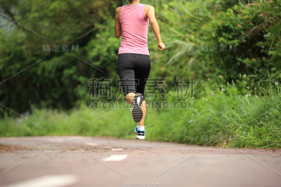 跑步运动员在森林小径上跑步。