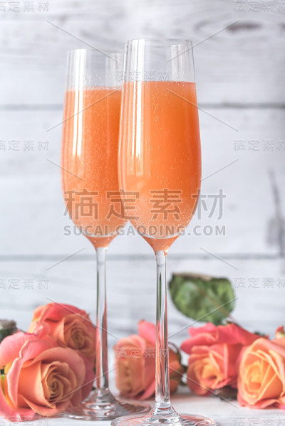 两杯贝里尼鸡尾酒和玫瑰花束