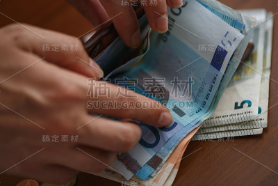 女人打开装满欧元钞票的钱包