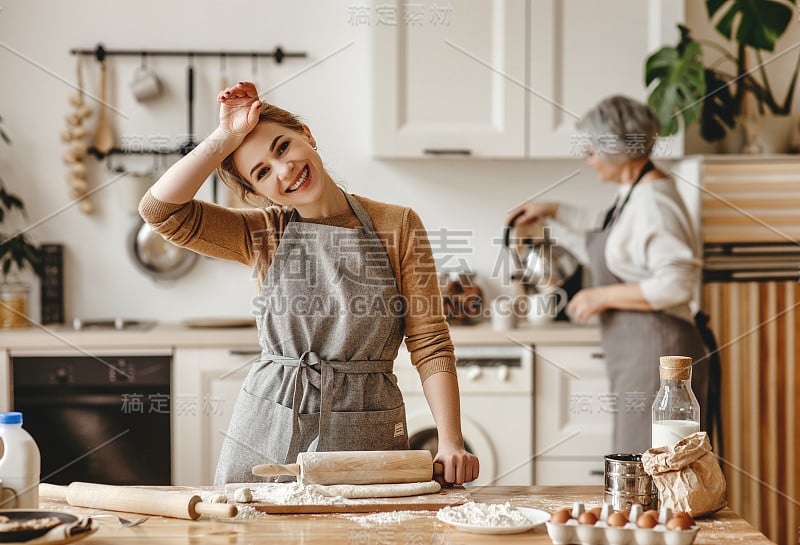 幸福的家庭奶奶老母婆婆和儿媳女儿在厨房做饭，揉面，烤饼干