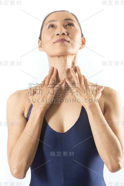 穿着蓝色紧身衣的成年女舞者在演播室跳舞。