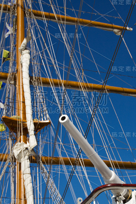 white gun on background masts of parsing ship mast