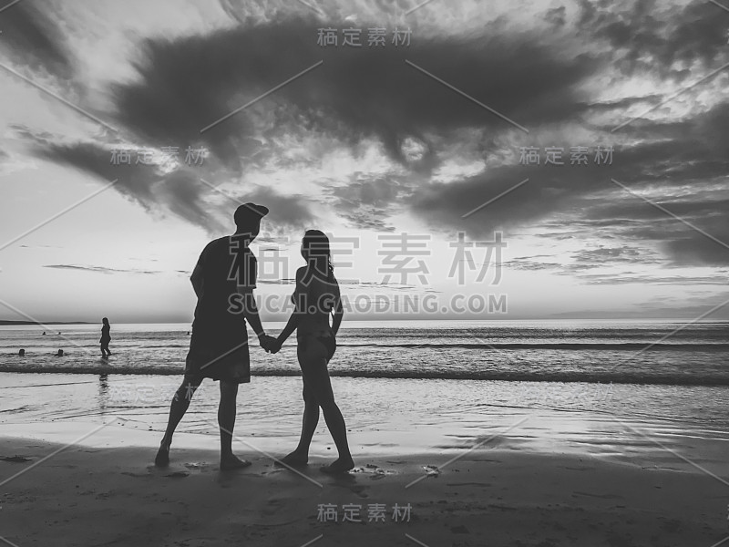 Silhouettes of couple in love feeling free during 