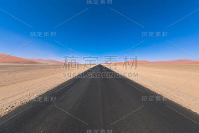 无尽的道路沿着纳米比亚的沙漠景观。