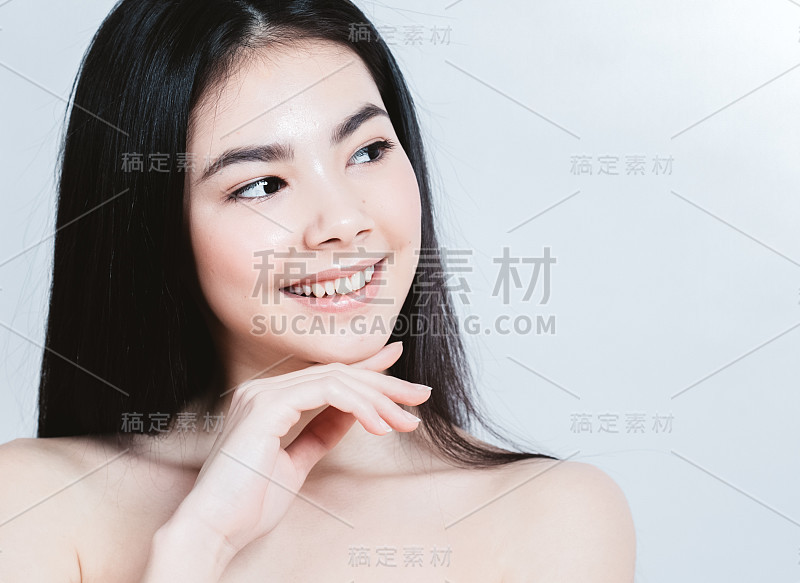 美丽亚洲女人的脸肖像。美丽的水疗模特女孩与完美的新鲜干净的皮肤。女性的微笑。青春护肤理念