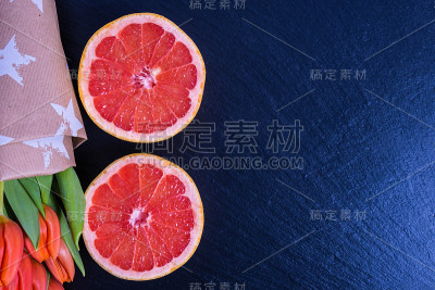 一束红色的郁金香和橙子