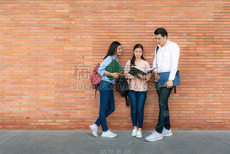 三位亚洲学生正在讨论大学里的备考、演讲、学习、备考学习。教育，学习，学生，校园，大学，生活理念。