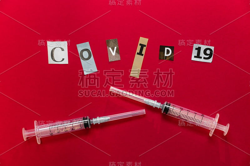 Two syringes and COVID-19 inscription