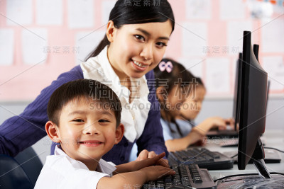 中文学校计算机课上的老师帮助学生