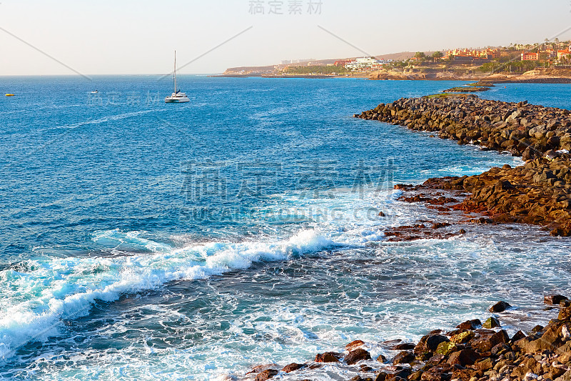 夏日日落时海岛海岸上的海浪。海滨度假胜地。旅游、旅游、度假。