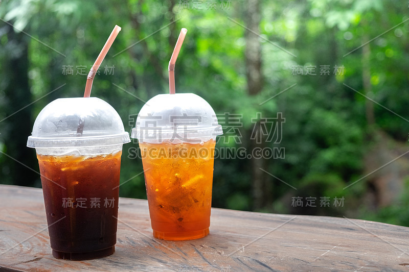 在木桌上喝一杯冰茶或冰咖啡，清爽宁静。适合假期休息。用于复制空间背景。