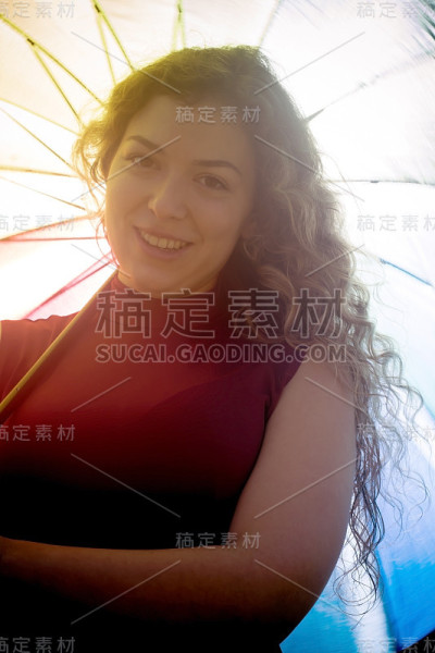 一个在阳光明媚的日子里打着伞的漂亮女人