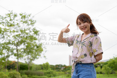 年轻美丽的亚洲女人在户外公园享受自然的肖像