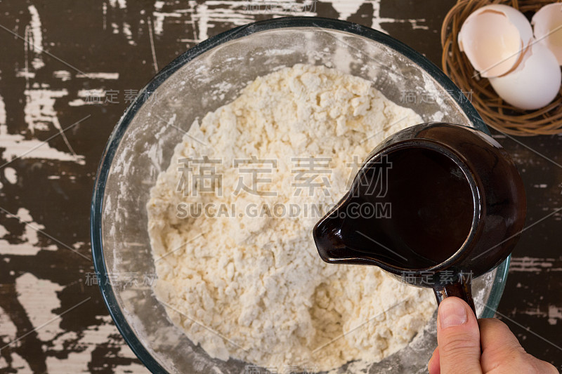 Woman hand holding ladle with hot water to put it 