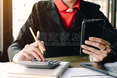商务女性看智能手机用户计算器意外财务账单收费孤立在办公室。
