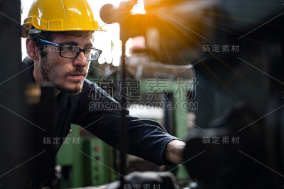 工厂的技术人员在机器的前面工作。