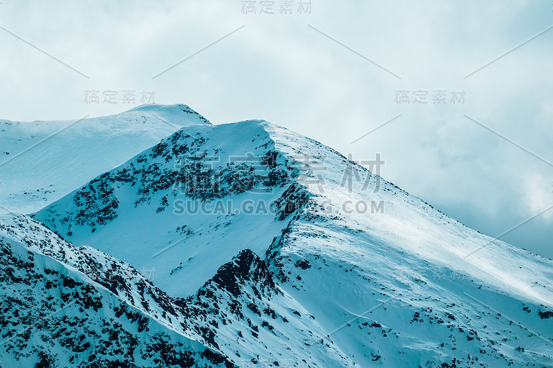 喜马拉雅高山雪峰景观，美丽的自然冬季背景。冰山顶，云天背景。