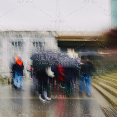 在西班牙毕尔巴鄂市，人们在雨天撑着雨伞行走