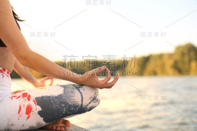 双手合十的女子做户外瑜伽，莲花式。健康和瑜伽的概念。