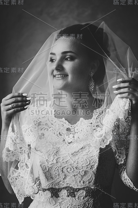 完美的时尚女性，美丽的妆容。穿着奢华婚纱的新娘。黑白照片。