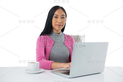 在白色背景下使用笔记本电脑的女性高管