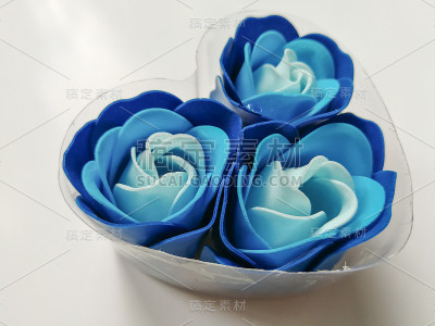 蓝色肥皂花在心形的塑料盒子里