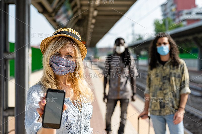 年轻女性旅行者拿着她的智能手机和疫苗护照证书。恢复使用现代设备上的数字健康证书在欧洲旅行。新冠肺炎大