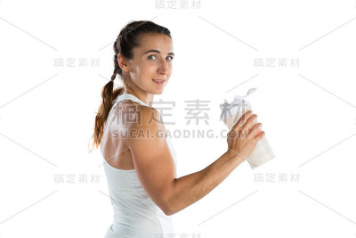 肖像微笑的女运动员拿着瓶子