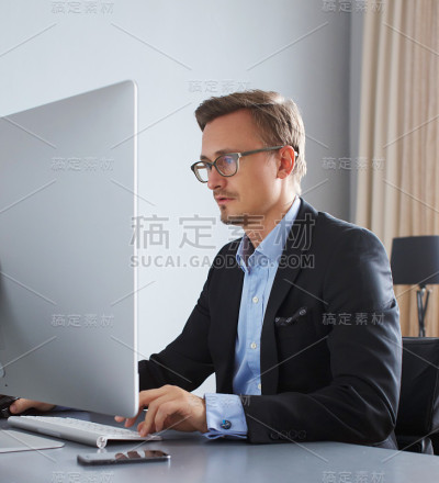 英俊的商人与电脑工作。