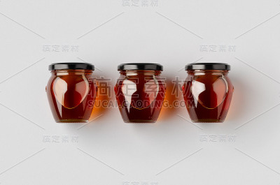 灰色背景上的三个蜂蜜罐模型。