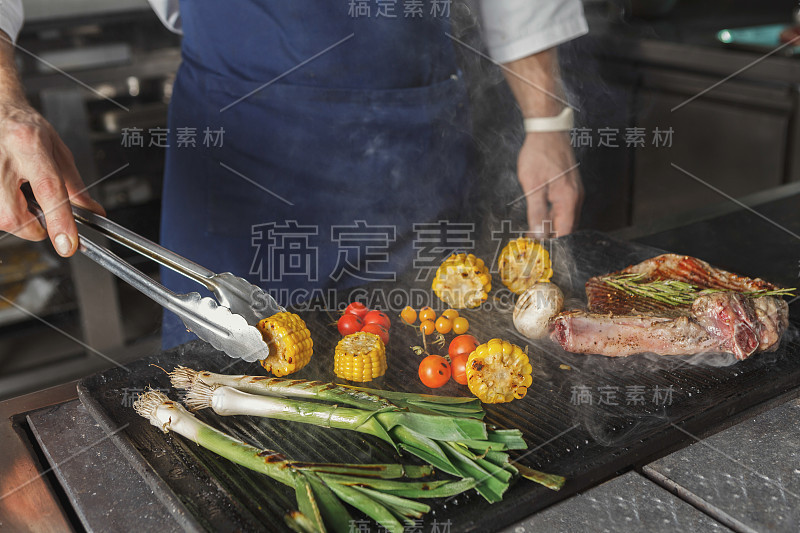 厨师在餐厅厨房烹饪多汁的牛排