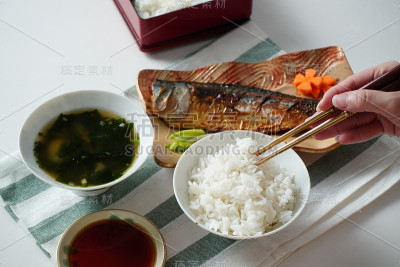 有人用筷子夹米饭和烤沙巴
