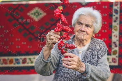老祖母用绳子拴住辣椒