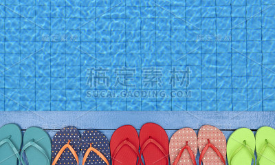 游泳池边的人字拖和沙滩浴巾