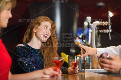 端上鸡尾酒的漂亮女孩