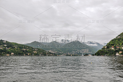 在多云的雨天漫步在科莫湖和建筑物