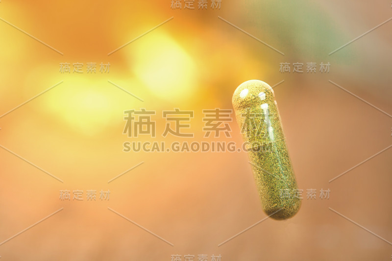 草药胶囊从草药上模糊背景。软焦点。