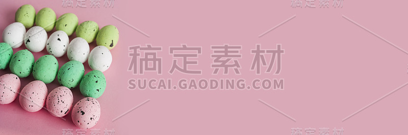 五颜六色的鹌鹑蛋，粉色背景上的复活节横幅
